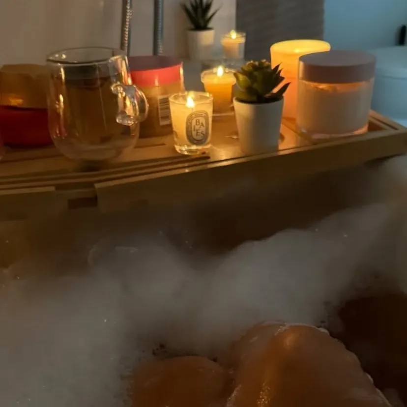 Warm candlelit bath filled with bubbles