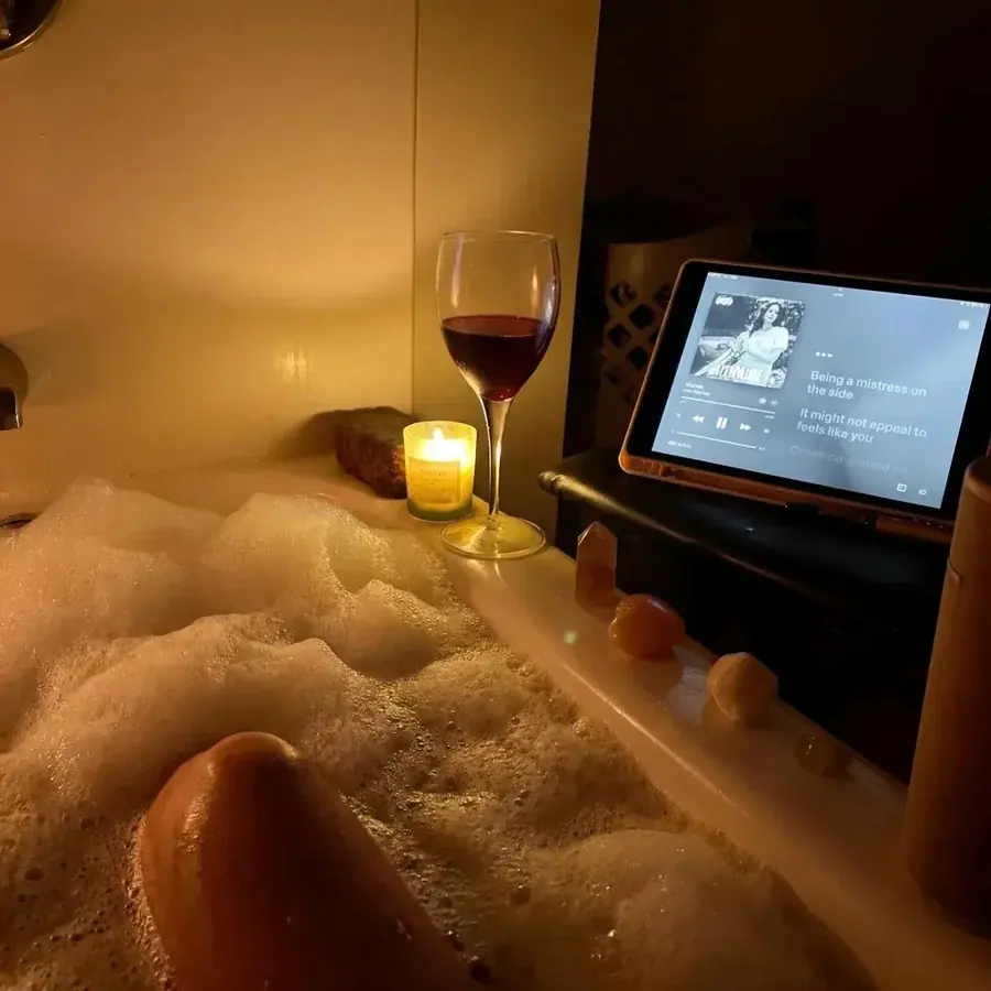 The view from inside a full warm bath, candle lit, with the door closed