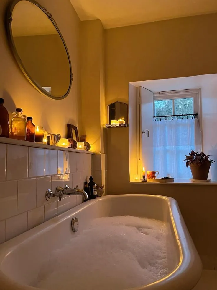 Golden lit bathroom with a full warm bath